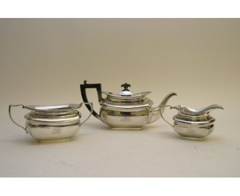 A three piece silver tea set with gadrooned edge, Birmingham hallmarks. 