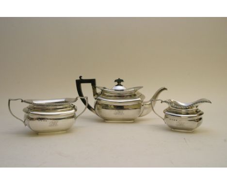 A three piece silver tea set with gadrooned edge, Birmingham hallmarks. 