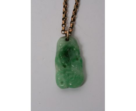 A small vintage carved jade pendent on a 9ct gold chain 
