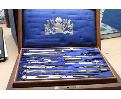 A rosewood case geometry set with blue velvet interior. 