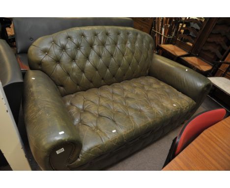 A 1950's Harrods green leather button back sofa 