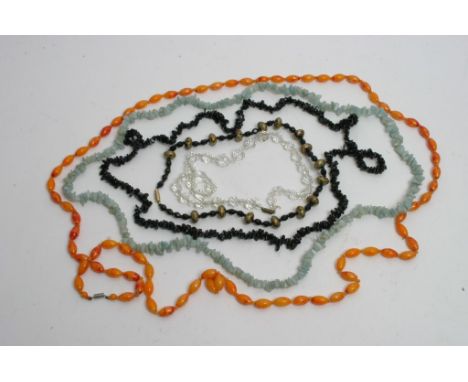 A bag containing various vintage necklaces 