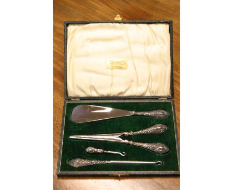 A cased silver handled button hook set, Birmingham 1913