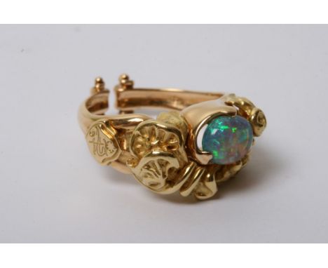 An 18ct gold ring with naturalistic form inset with an opal 