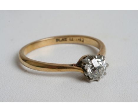 An 18ct gold ring inset with a brilliant cut vintage solitaire diamond