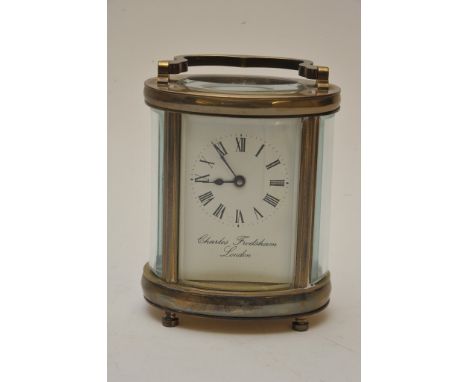 A brass carriage clock of oval shape Charles Frodsham London