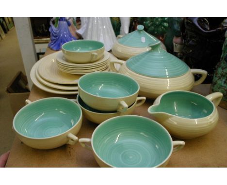 A Clarice Cliff cream and turquoise glazed part dinner service