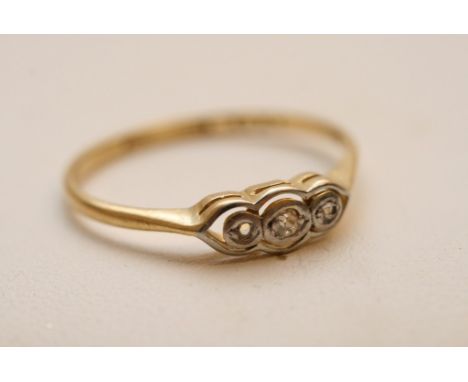 An 18ct gold ring set with a row of three diamonds 