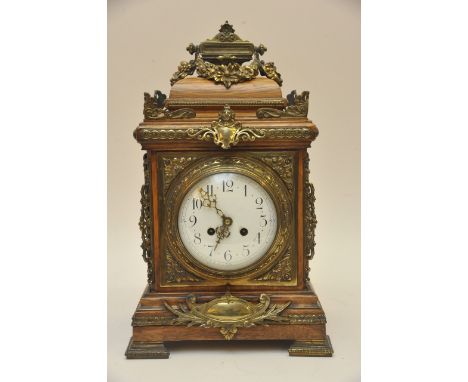 A walnut 19th Century French brass mounted mantel clock, the enamel dial with Arabic numerals 