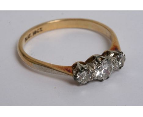 An 18ct yellow gold and platinum ring with three diamonds