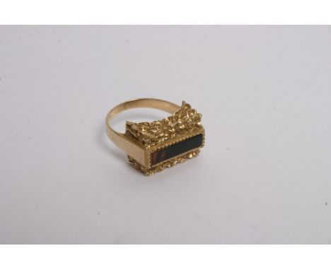 A 9ct gold ring set with polished stone in and oblong setting