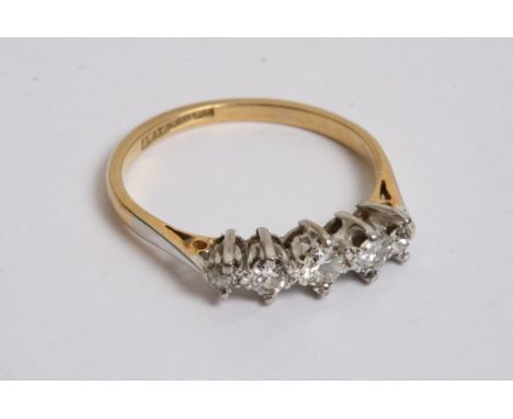 An 18ct gold ring with a row of five diamonds