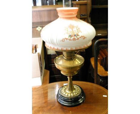 A brass oil lamp with shade