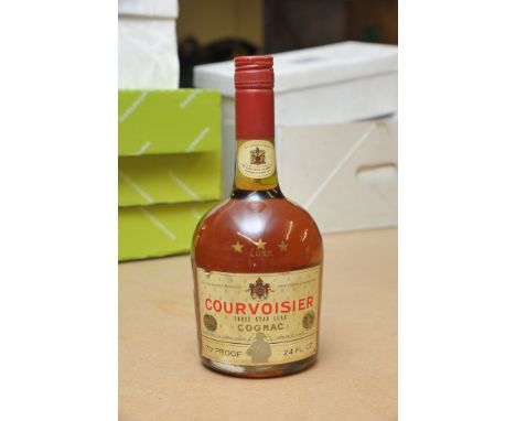 A vintage bottle of courvoisier brandy with applied label "By Appointment to the late king George VI (full level ) 