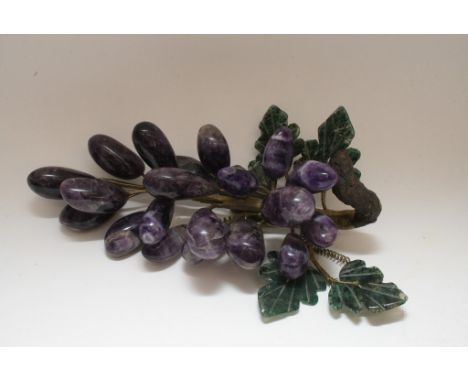 An attractive, ornamental sculptural study of fruit comprising of a bunch of nineteen amethyst grapes and five jade leaves, e