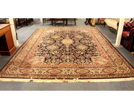 A large Persian style woollen carpet, 365 x 265cm.