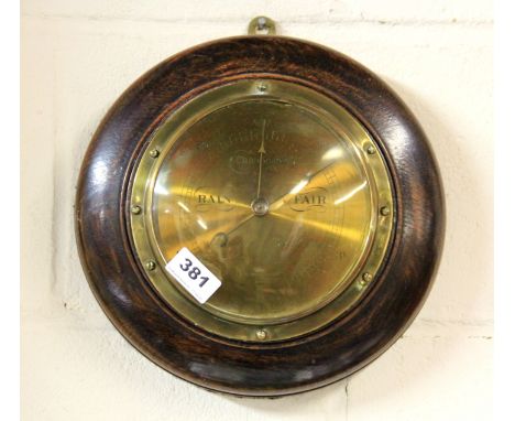A 1920's oak and brass barometer, Dia. 28cm.