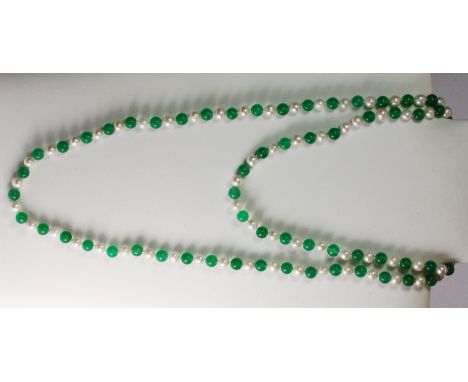 A cultured pearl and polished jade bead necklace.