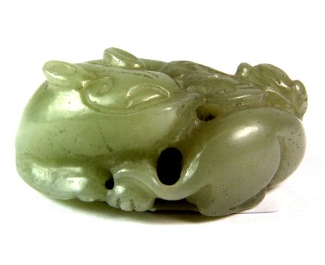 An interesting Chinese nephrite jade carving of a dragon and baby playing with a bat shaped cash, probably early 20th century