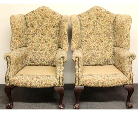 A pair of 1920's ball and claw foot button backed wing chairs.