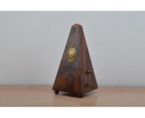 A 19th century Metronome de Maelzel, of London, mahogany case, appears to work, brass name plate to the front, raised on bras
