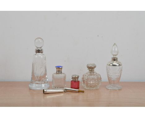 A collection of silver and glass items, comprising five perfume bottles, one with a silver and blue enamel cap, another cranb