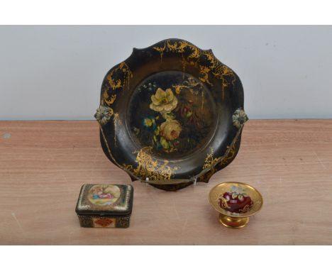 A 19th century hand painted papier mache shaped plate with handle, floral design with heightened gilt, 23cm diameter, togethe