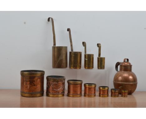 Brass and copper measuring containers, comprising a set of four brass handled measuring vessels, by The Oriental Metal Pressi