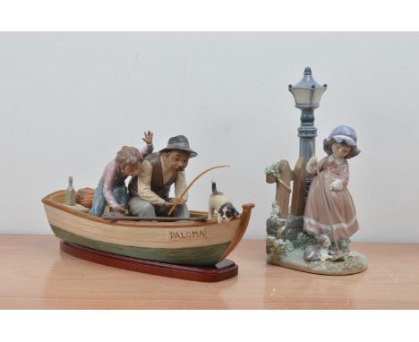 Two Lladro ceramic figural groups, comprising a father, son and dog on a fishing boat, with a wooden stand 37cm in length and