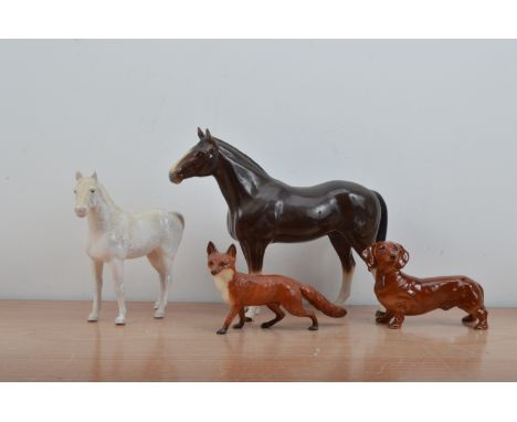 Four ceramic animals, comprising a Beswick fox and sausage dog, a Sylvac white horse and a large unmarked horse 30cm high, so