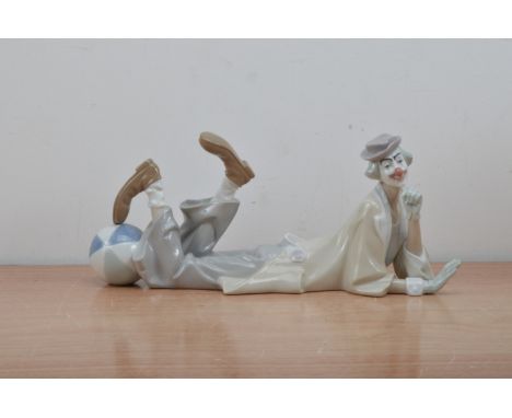 A Lladro ceramic figure of a clown, lying down with a balloon by its foot, marked to the underside, 38cm diameter 