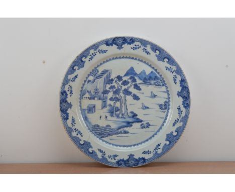 A large Chinese blue and white ceramic charger, probably 19th century, cracked and staple repaired, AF 55cm diameter 