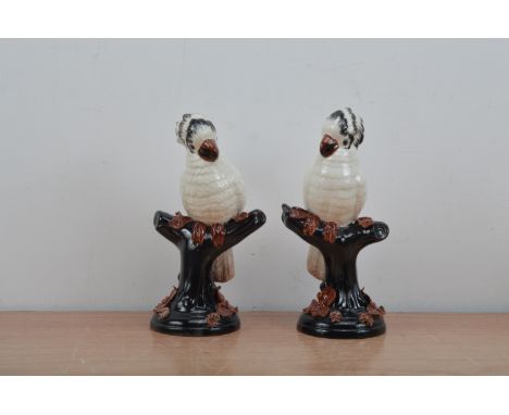 A pair of Italian ceramic Cockatoo's, both on perches and 24cm high (2) 
