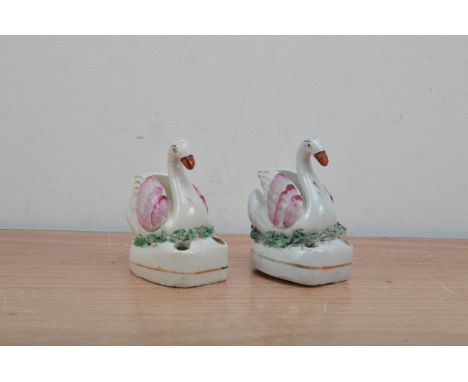 A pair of 19th century Staffordshire Swan inkwell, hand painted design, both approx. 8.5cm high AF (2) 