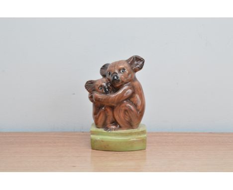 An early 20th century pottery figurine of a Koala bear and its cub, by Goldscheider, marked to the underside of the base, 15c