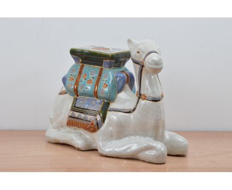 A 20th century ceramic camel, probably from the middle east, with some wear 31cm H x 38cm W 