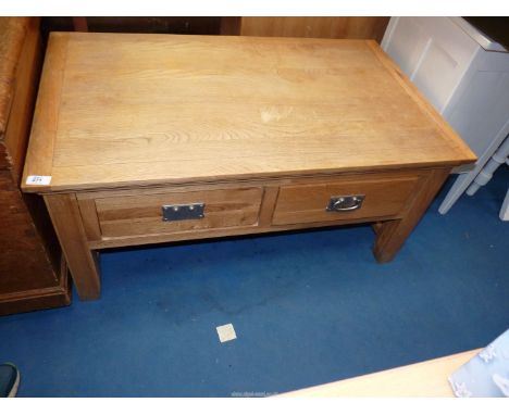 A light Oak coffee table with two frieze drawers (one handle a/f), 39 1/2" wide x 23 3/4" depth x 18 1/2" high.