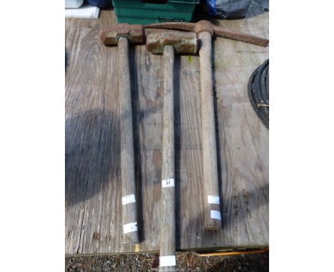Two sledge hammers and a pick axe.