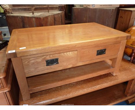 A light oak Coffee Table with two frieze drawers and a lower shelf, 38 1/2" x 23 1/2" x 18" high.