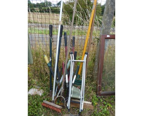 A quantity of miscellaneous garden tools to include: rake, broom, shears, etc.