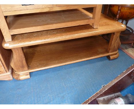 A large light oak coffee/low table with lower shelf, 54" wide x 26" depth x 18" high.