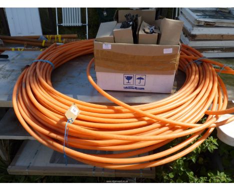 A large quantity of orange piping, a box of pipe staples, etc.