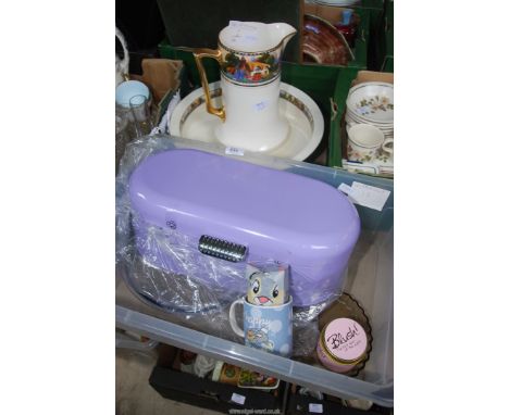 A wash jug and basin, a metal tin, mugs, etc.