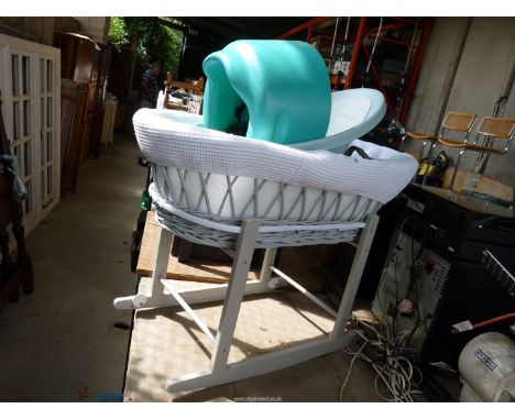 A baby bath, rocking cot and potty.