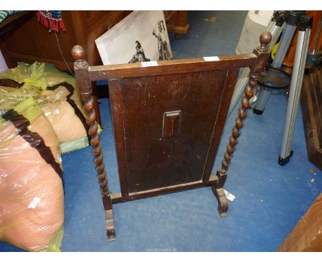 An Oak firescreen with barley twist supports.