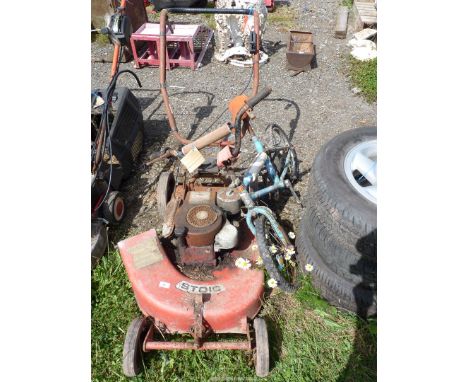A children's bicycle and a "Stoic" lawn mower with a Briggs and Stratton engine.