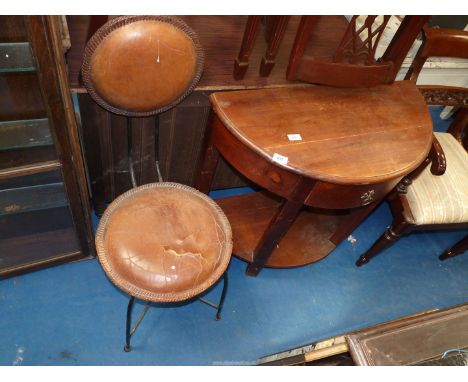 A metal framed chair with circular leather back and seat and a bow fronted demi-lune hall table with drawer and shelf  31" wi
