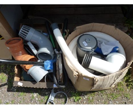 Two boxes containing a water filter pump, tools, piping, etc.