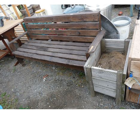 A slatted garden bench, 58" wide x 31" high and a wooden planter.