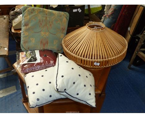A wooden light shade, cushions, massage cushion.